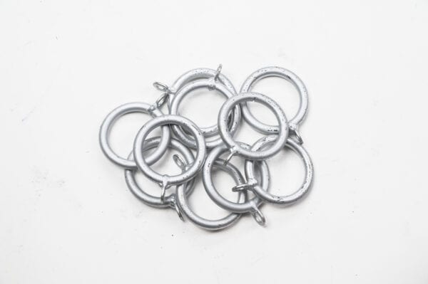 A set of Standard Curtain Rings with small hooks displayed on a white background.