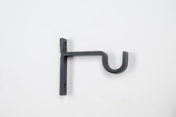 The Classic Center Support Bracket in black elegantly holds curtains or rods with a right-side hook against a white backdrop.