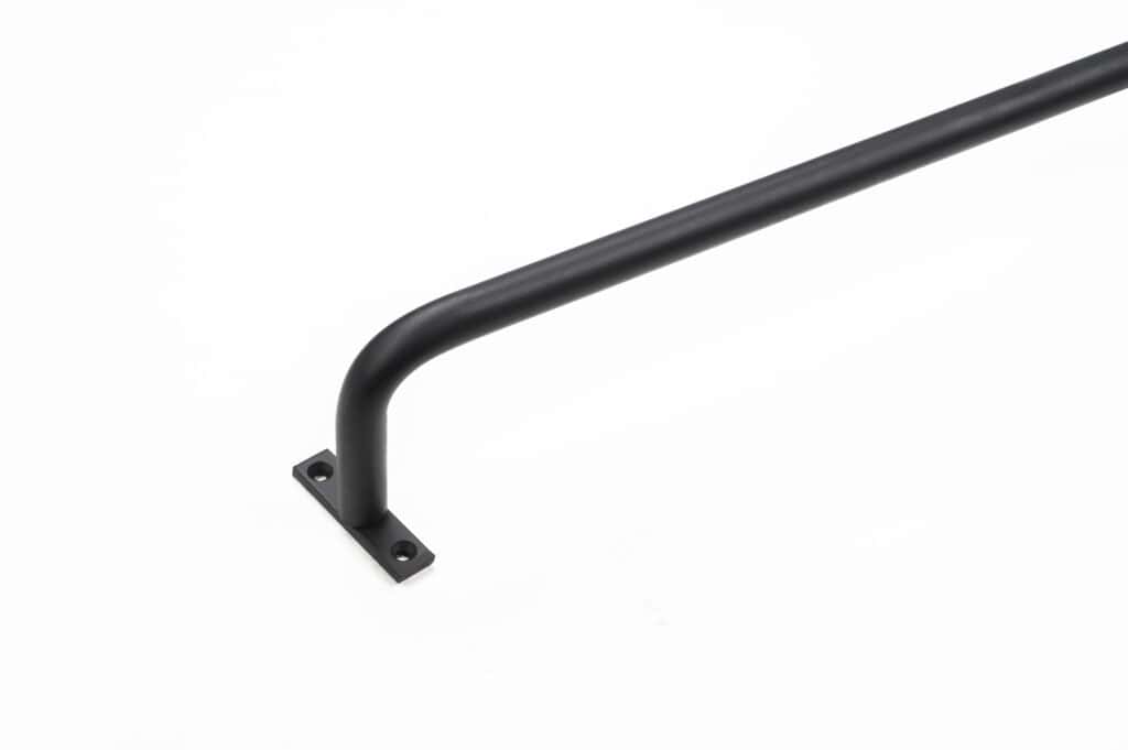 A black metal handrail with a simple design is attached to a small rectangular base with two screw holes, placed on a white background.