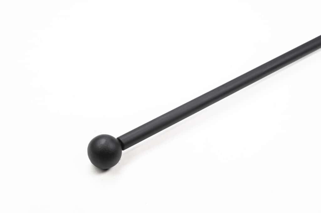 A black metal rod with a spherical tip is positioned diagonally against a plain white background.