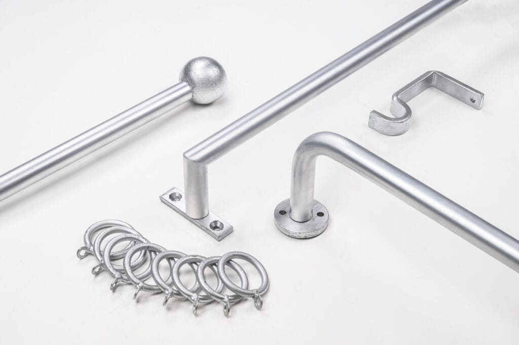 Silver curtain rod with mounting brackets and rings, perfect for enhancing any room's decor, displayed on a white background.