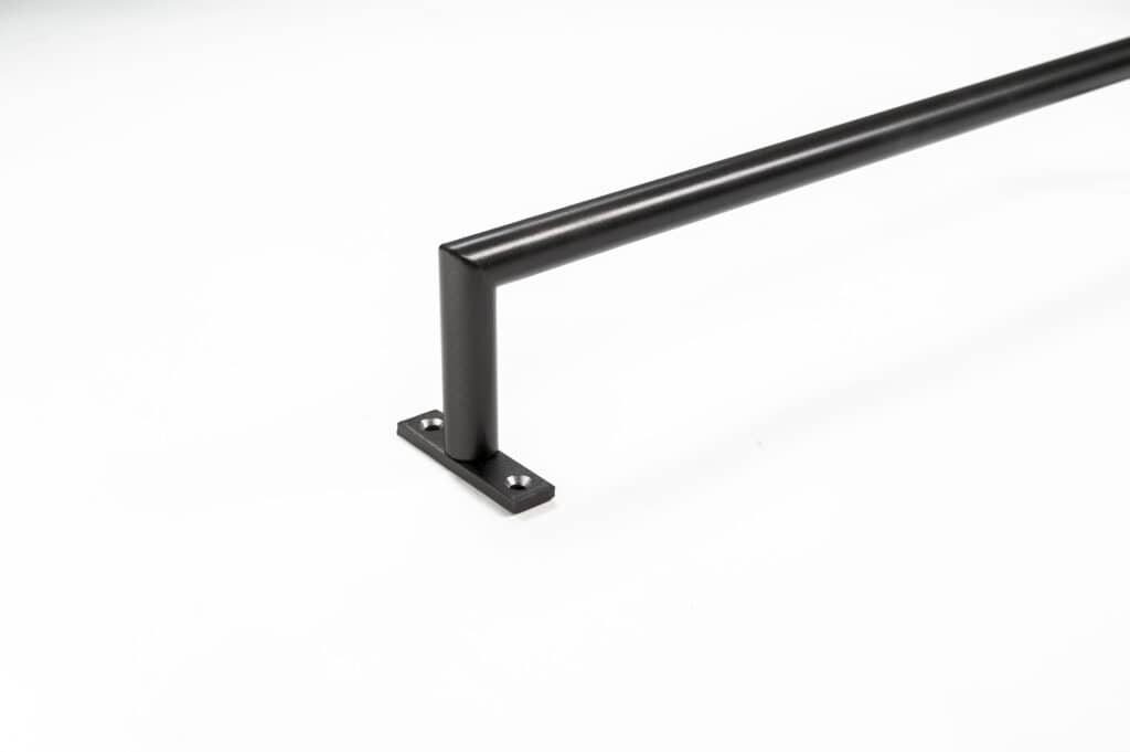Black metal bar with a right-angle bend, ideal for curtain rods, mounted on a flat base plate with two screw holes, on a white background.