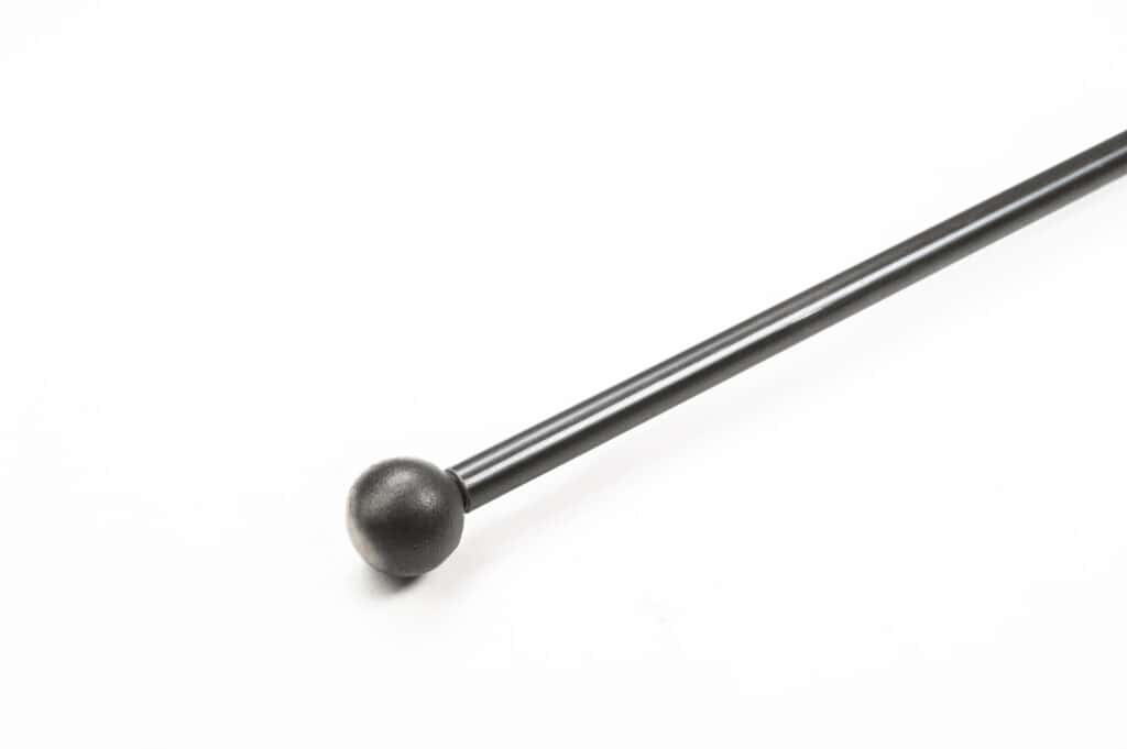 A black metal rod with a round ball at one end, positioned diagonally on a white background.